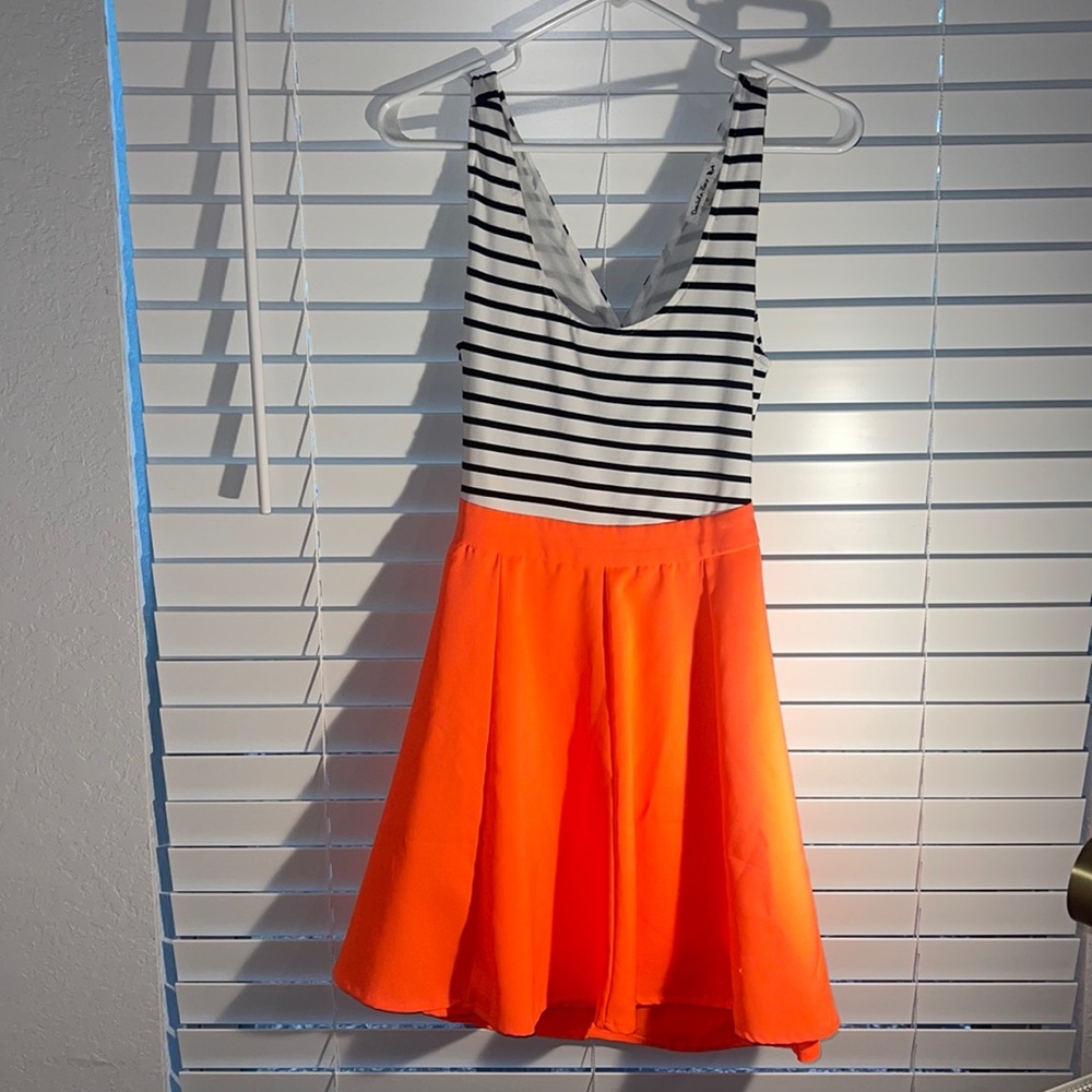 Fluorescent orange dress, crosses in back.